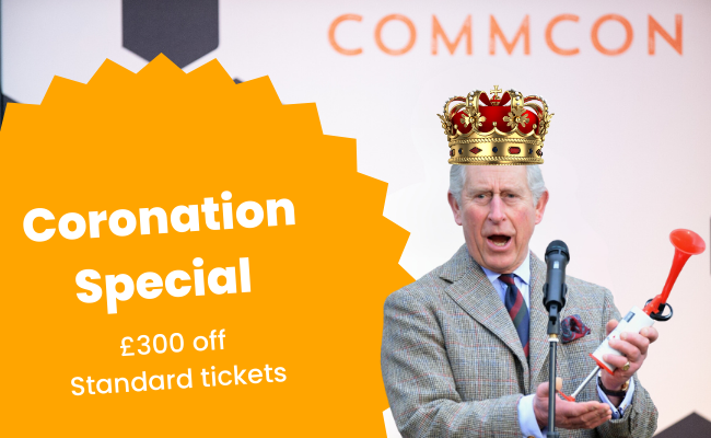 King Charles with a crown and airhorn stands in front of a microphone and behind a CommCon backdrop, next to a graphic that says 'Coronation Special £300 off Standard tickets'