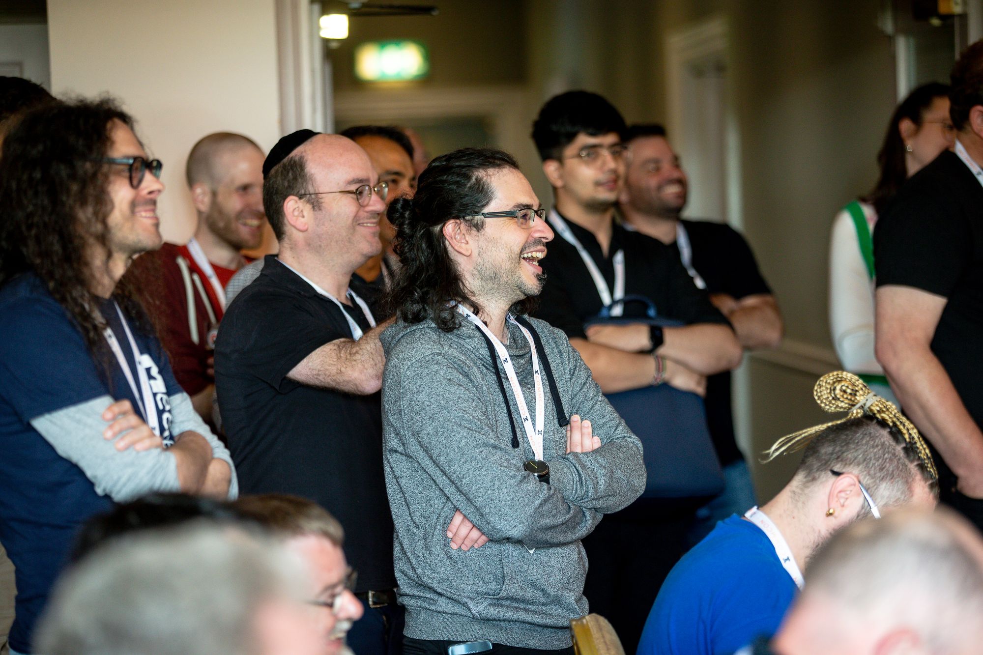 Attendees smiling and laughing whilst watching a talk at CommCon 2023